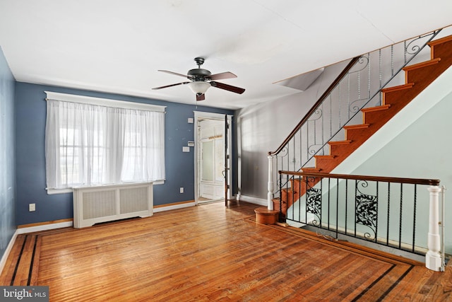 entryway featuring ceiling fan, radiator, and light hardwood / wood-style flooring