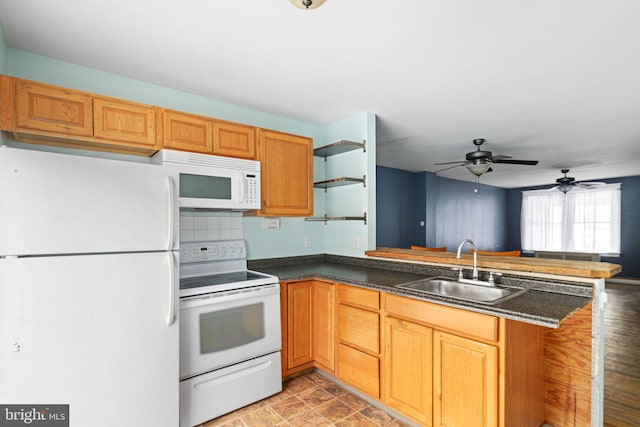 kitchen with white appliances, sink, decorative backsplash, ceiling fan, and kitchen peninsula