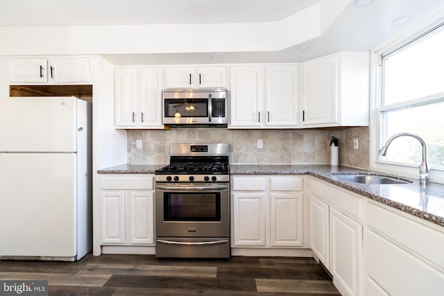 kitchen featuring dark wood-type flooring, sink, white cabinets, and stainless steel appliances