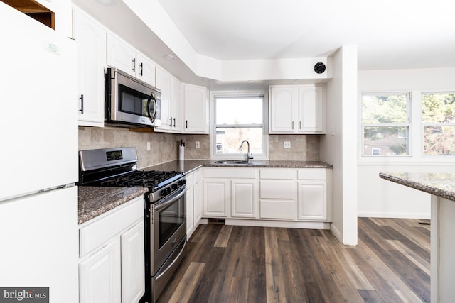 kitchen featuring white cabinets, stainless steel appliances, dark wood-type flooring, and sink