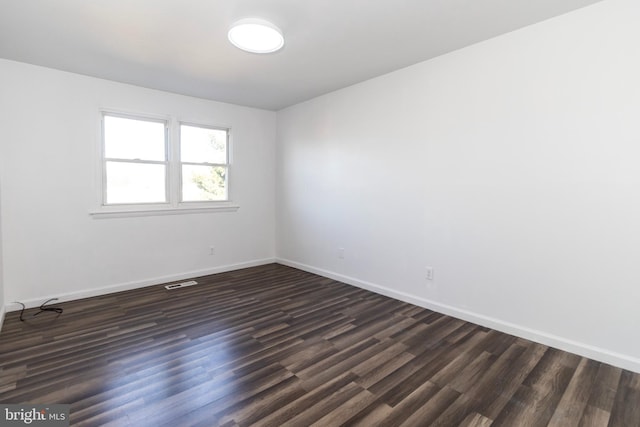 unfurnished room with dark hardwood / wood-style floors