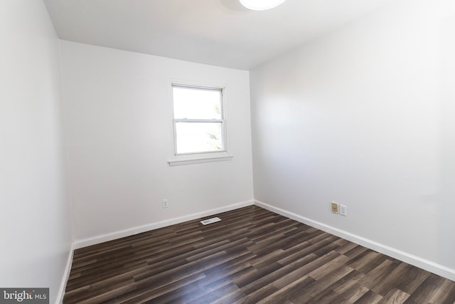 empty room with dark hardwood / wood-style floors