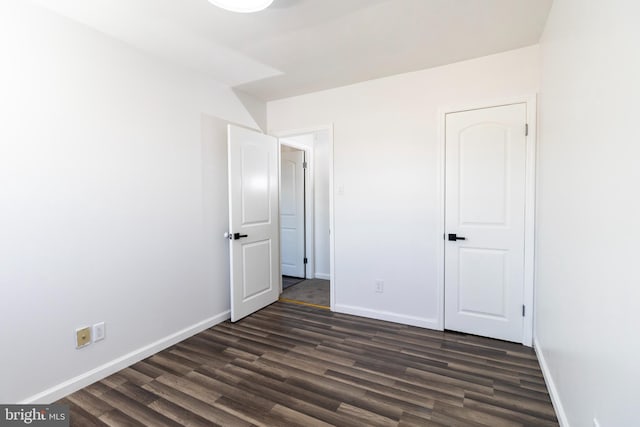 unfurnished bedroom featuring dark wood-type flooring