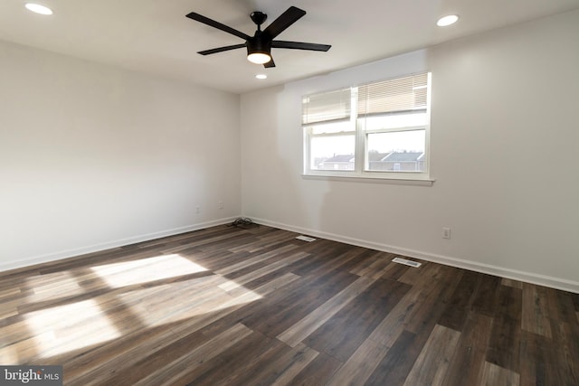 spare room with ceiling fan and dark hardwood / wood-style flooring