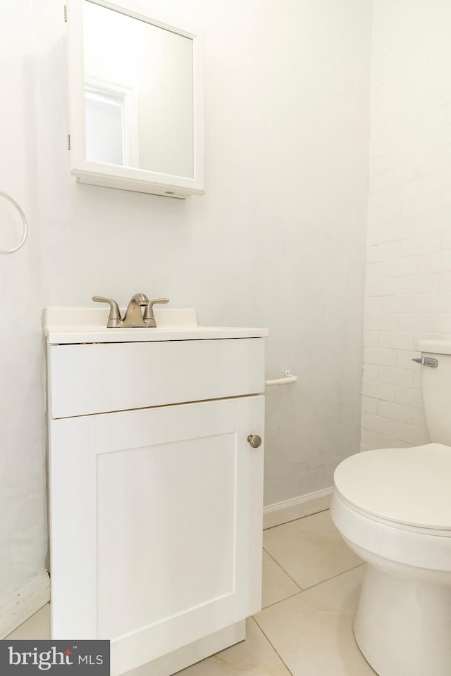 bathroom featuring tile patterned flooring, vanity, and toilet