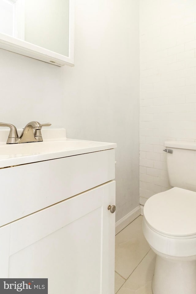 bathroom featuring toilet, vanity, and tile patterned floors