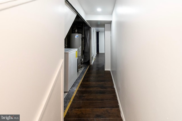 corridor featuring dark hardwood / wood-style floors and water heater