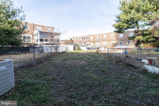 view of yard featuring central air condition unit