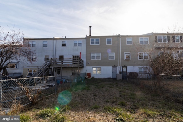 back of property featuring central AC unit and a deck