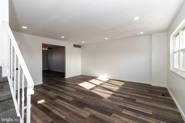 spare room with ceiling fan and dark hardwood / wood-style flooring