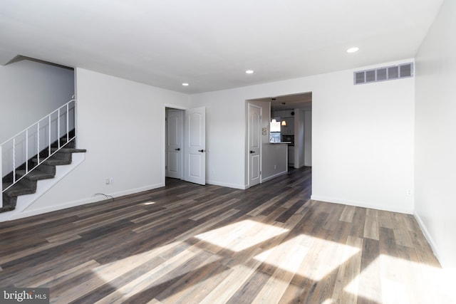 unfurnished living room with dark wood-type flooring