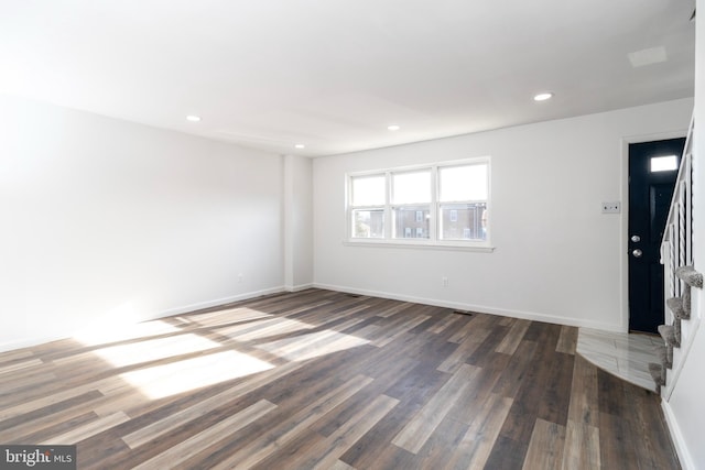 empty room featuring dark wood-type flooring