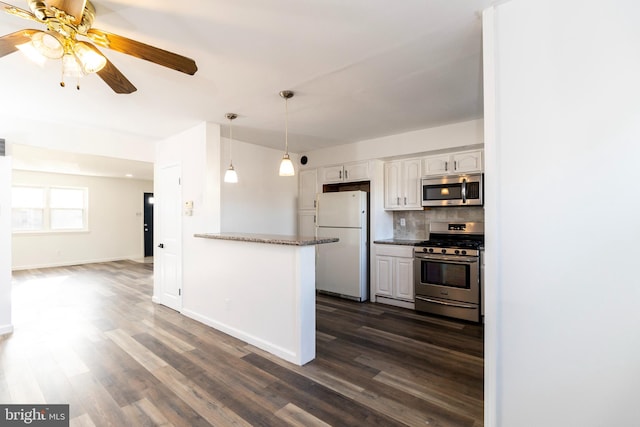 kitchen with backsplash, kitchen peninsula, appliances with stainless steel finishes, dark hardwood / wood-style flooring, and white cabinetry