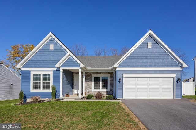 view of front facade featuring a front yard and a garage