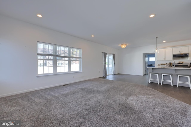 unfurnished living room with dark hardwood / wood-style floors