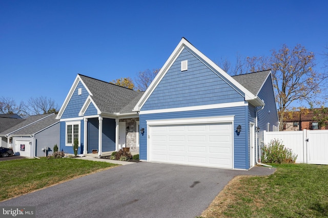 view of front of house featuring a front lawn and a garage