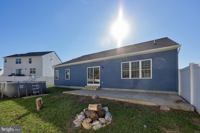 rear view of house with a yard and a patio area