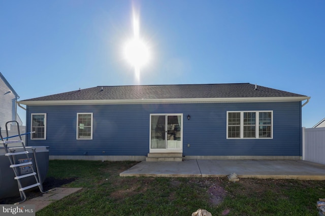 rear view of house featuring a patio area and a yard