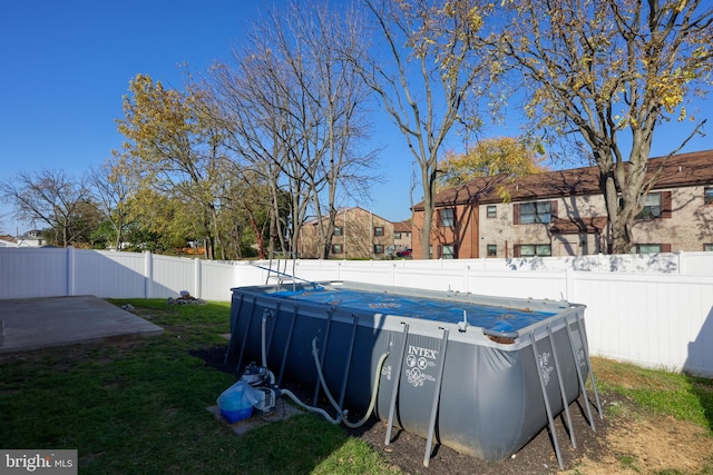 view of swimming pool with a yard and a patio