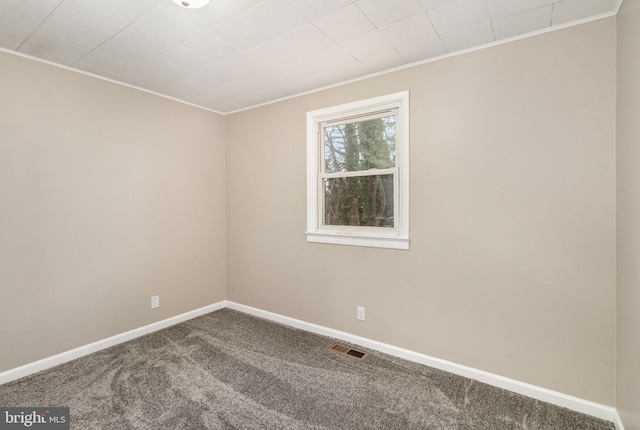 carpeted spare room featuring ornamental molding