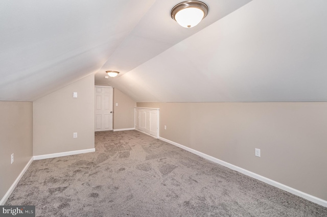 additional living space featuring light carpet and lofted ceiling