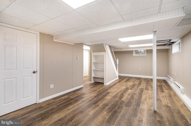 125 Evergreen St, Hummelstown, PA 17036 - below grade area with a paneled ceiling, a baseboard radiator, baseboards, and dark wood finished floors