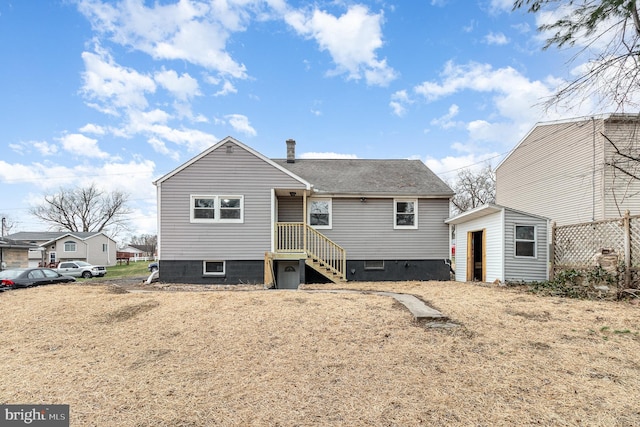 125 Evergreen St, Hummelstown, PA 17036 - rear view of property featuring roof with shingles, a shed, and an outbuilding