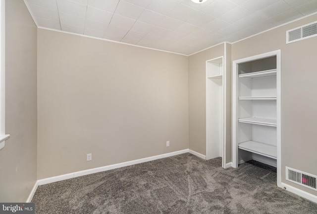 unfurnished bedroom featuring crown molding, a closet, and carpet floors