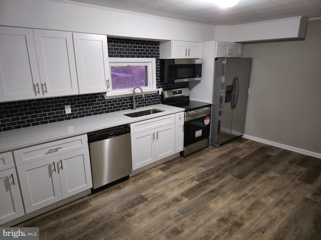 kitchen featuring dark hardwood / wood-style floors, sink, white cabinetry, and stainless steel appliances