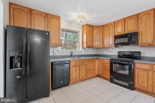 kitchen with black appliances, light tile patterned floors, sink, and tasteful backsplash