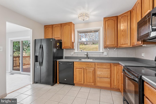 kitchen with black appliances, decorative backsplash, sink, and light carpet