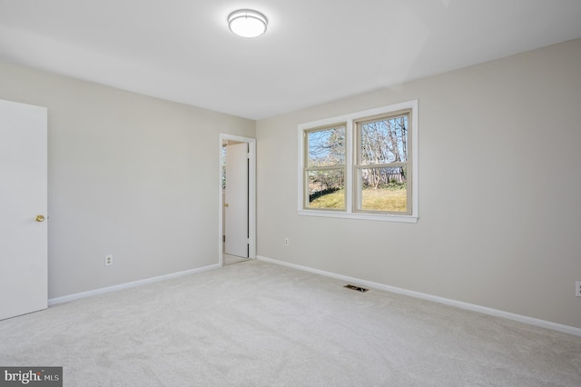 empty room featuring light colored carpet