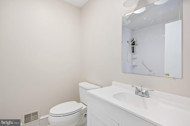 bathroom with walk in shower, vanity, and toilet