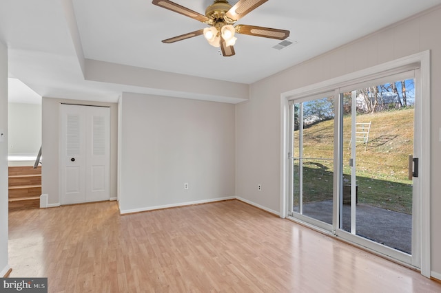 empty room with light hardwood / wood-style floors and ceiling fan