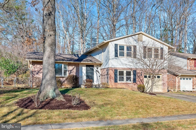 tri-level home featuring a garage and a front lawn