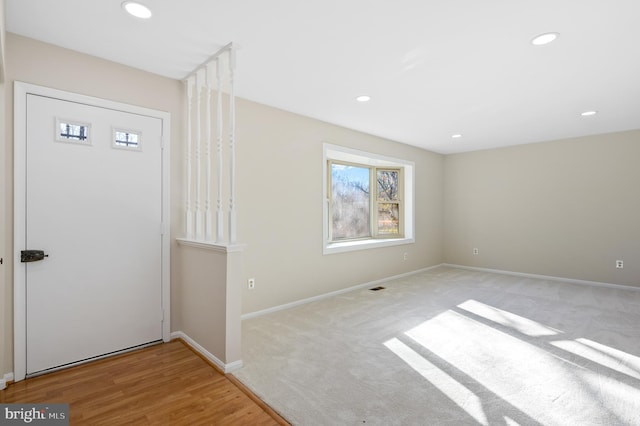 foyer entrance featuring light colored carpet