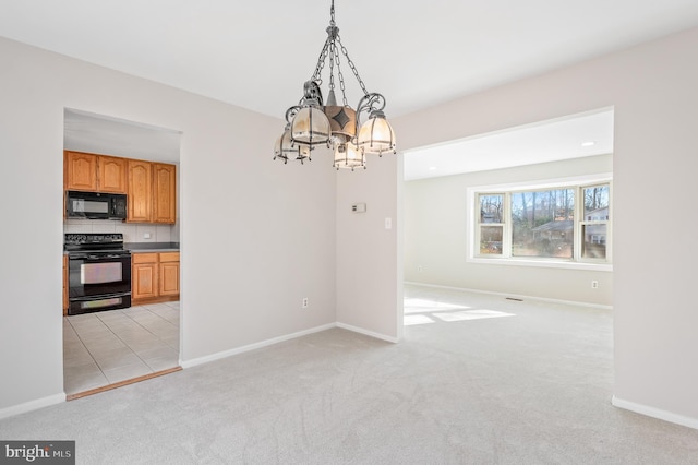 unfurnished dining area with a chandelier and light colored carpet