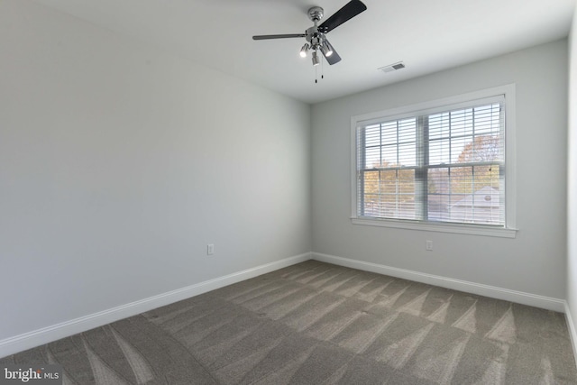 spare room featuring ceiling fan and carpet floors