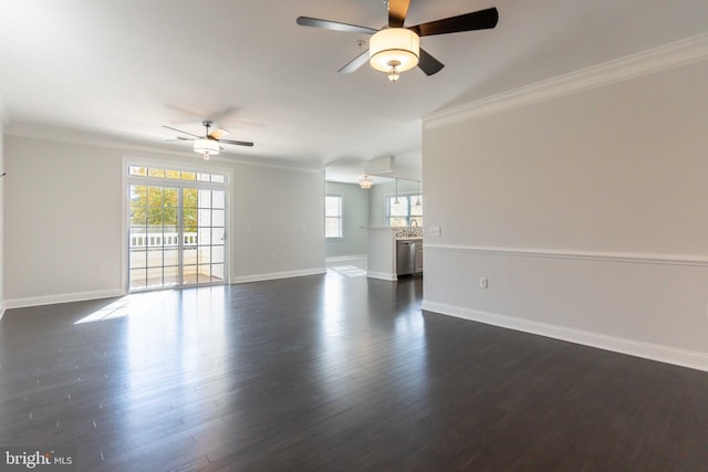 unfurnished room with dark hardwood / wood-style flooring, ceiling fan, and ornamental molding