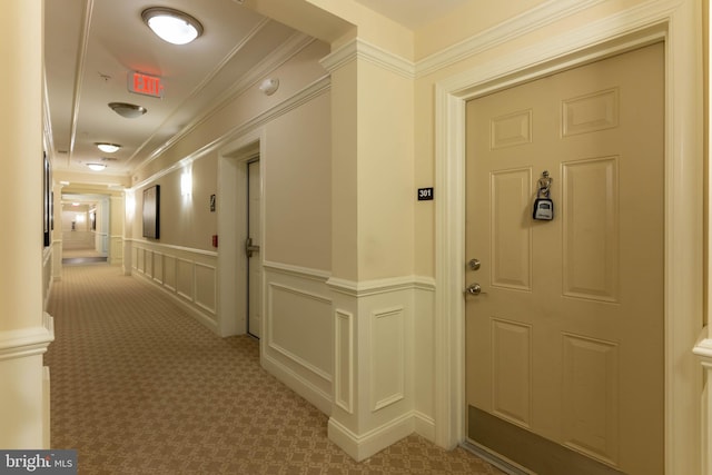 corridor with light carpet and crown molding