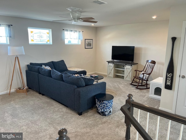 living room featuring carpet, plenty of natural light, and ceiling fan