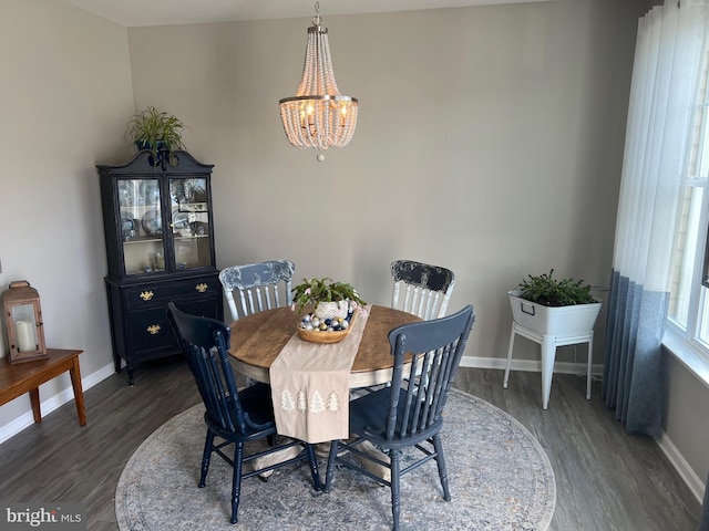 dining room featuring dark wood-type flooring and a chandelier