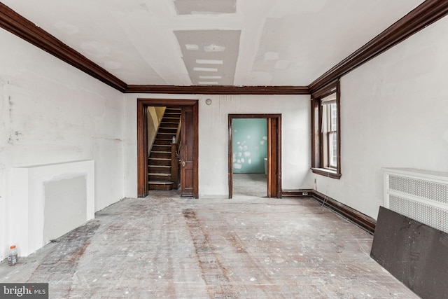 unfurnished living room featuring crown molding