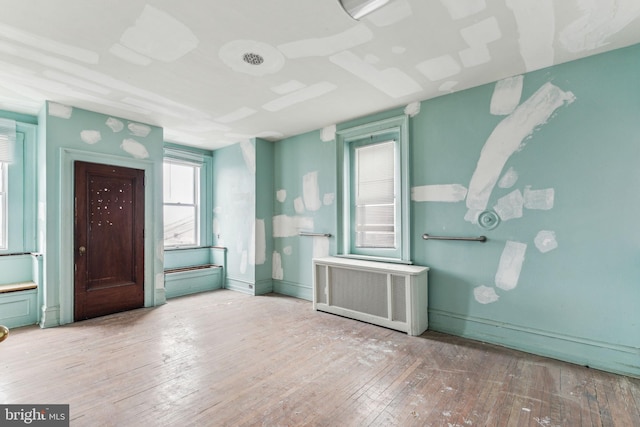 entrance foyer with wood-type flooring and radiator