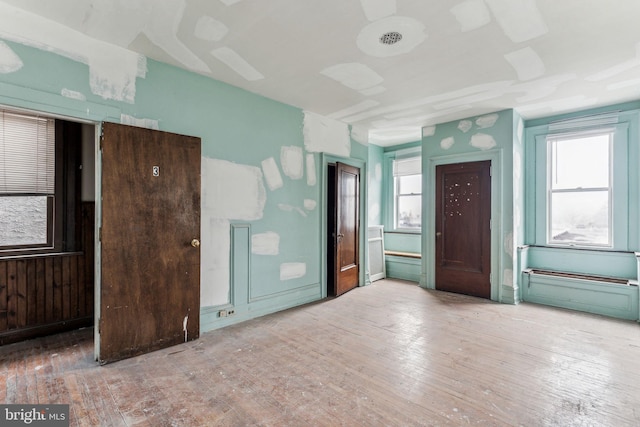 empty room with hardwood / wood-style flooring