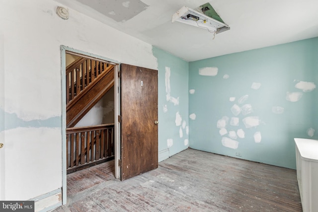 unfurnished room with wood-type flooring