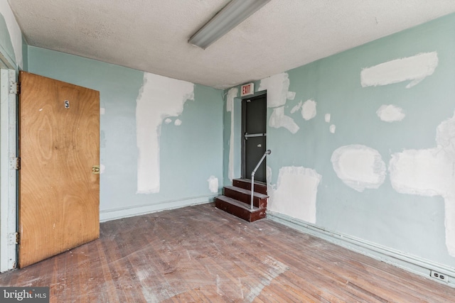 empty room featuring hardwood / wood-style floors and a textured ceiling