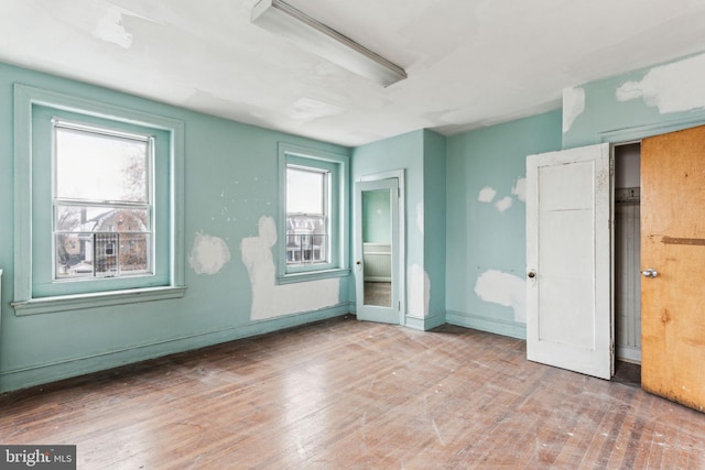 unfurnished bedroom with hardwood / wood-style floors and a closet