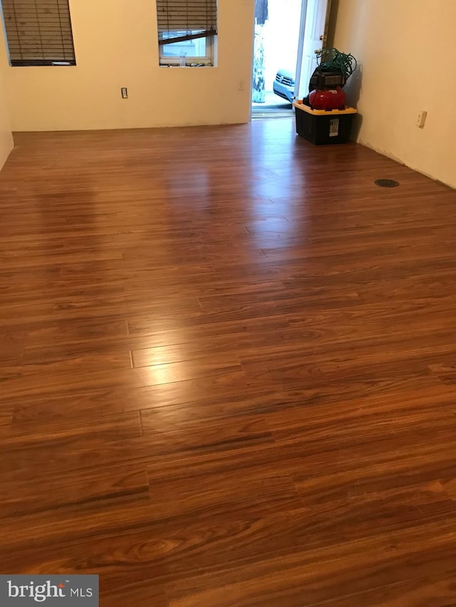 empty room with dark wood-type flooring