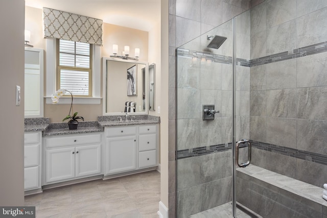 bathroom featuring vanity and tiled shower